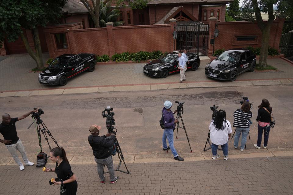 Press gather outside the home of Oscar Pistorius' uncle in the upmarket suburb of Waterkloof (AP)