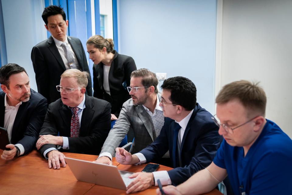 Dr. Jeremi Mountjoy, an anesthesiologist from Massachusetts General Hospital, left, meets with Dr. Alfred Yoon, a chief resident of plastic surgery at the University of Michigan, Dr. Gina Sacks, chief resident of plastic surgery at the University of Michigan, Dr. David Brown, plastic surgeon at the University of Michigan, Dr. Shawn Diamond, a plastic surgeon with Texas Tech Physicians of El Paso, Dr. Gennadiy Fuzaylov, a pediatric anesthesiologist from Massachusetts General Hospital and founder of Doctors Collaborating to Help Children, and Dr. Piotr Tomaka, deputy director of medical affairs at the Independent Public Health Care Facility in Leczna, Poland on Monday, May 15, 2023 to coordinate a week of surgeries of 20 Ukrainian children.