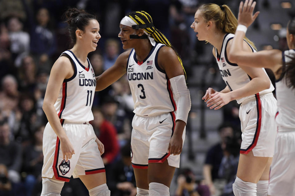 UConn's Lou Lopez Senechal (11), Aaliyah Edwards (3), and Dorka Juhasz celebrate during the first half of an NCAA college basketball game against Marquette in the semifinals of the Big East Conference tournament at Mohegan Sun Arena, Sunday, March 5, 2023, in Uncasville, Conn. (AP Photo/Jessica Hill)