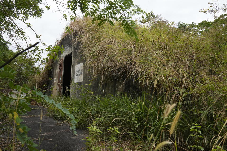 Trees and weed grow outside an abandoned weapons storage structure in what used to be America's largest overseas naval base at the Subic Bay Freeport Zone, Zambales province, northwest of Manila, Philippines on Monday Feb. 6, 2023. The U.S. has been rebuilding its military might in the Philippines after more than 30 years and reinforcing an arc of military alliances in Asia in a starkly different post-Cold War era when the perceived new regional threat is an increasingly belligerent China. (AP Photo/Aaron Favila)