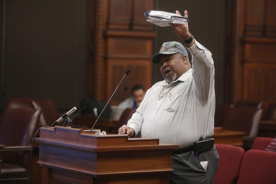 Bob Billings of Rochester holds up his stack of RG &E bills asking how he can have a $1,500 bill for a church that's open once a week during a public forum about complaints about RG&E and NYSEG held at Rochester City Hall.  Billings said his bills have fluctuated between having a credit on his account to a high bill.   The forum was hosted by the New York State Department of Public Service who also had people there to assist customers in filing a complaint.