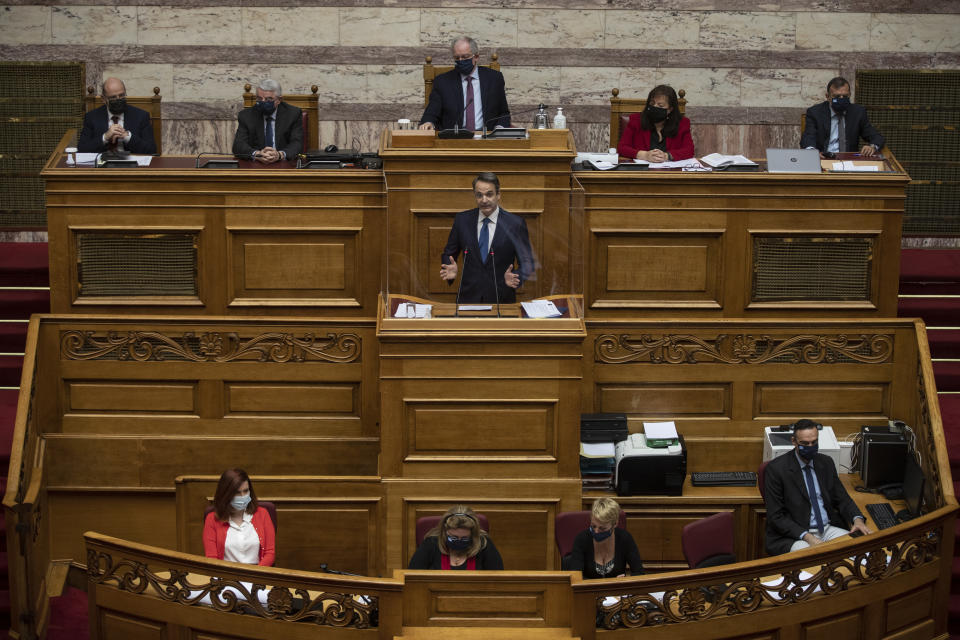 Greek Prime Minister Kyriakos Mitsotakis speaks during a parliamentary session in Athens, Thursday, Feb. 25, 2021. Mitsotakis has promised to outline proposed legal changes in parliament on Thursday to make it easier for victims of sexual assault to report the crimes. (AP Photo/Petros Giannakouris)