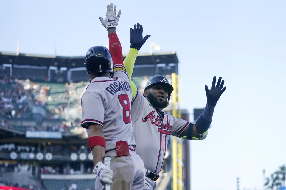 Atlanta Braves' Marcell Ozuna, right, is congratulated by Eddie Rosario (8) after hitting a two-run home run that scored Matt Olson during the sixth inning of a baseball game against the San Francisco Giants in San Francisco, Sunday, Aug. 27, 2023. (AP Photo/Jeff Chiu)