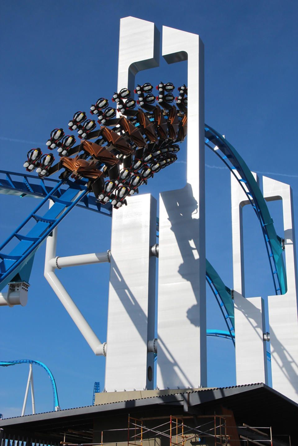 This April 4, 2013 photo provided by Cedar Point shows an empty train during a test run above a new main entrance area on Cedar Point’s new GateKeeper roller coaster in Sandusky, Ohio. The coaster will turn riders upside down six times and soar above a new main entrance on seats that extend sideways from the track, with nothing above or below them. (AP Photo/Cedar Point)