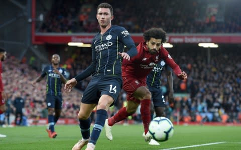 Manchester City's French defender Aymeric Laporte (L) vies with Liverpool's Egyptian midfielder Mohamed Salah - Credit: AFP