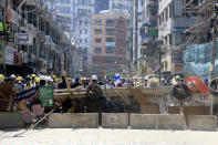 Protesters set up barricade during an anti-coup protest march in Yangon, Myanmar, Monday, March 1, 2021. Defiant crowds returned to the streets of the country's biggest city on Monday, determined to continue their protests against the military's seizure of power a month ago, despite security forces having killed at least 18 people around the country just a day earlier. (AP Photo)