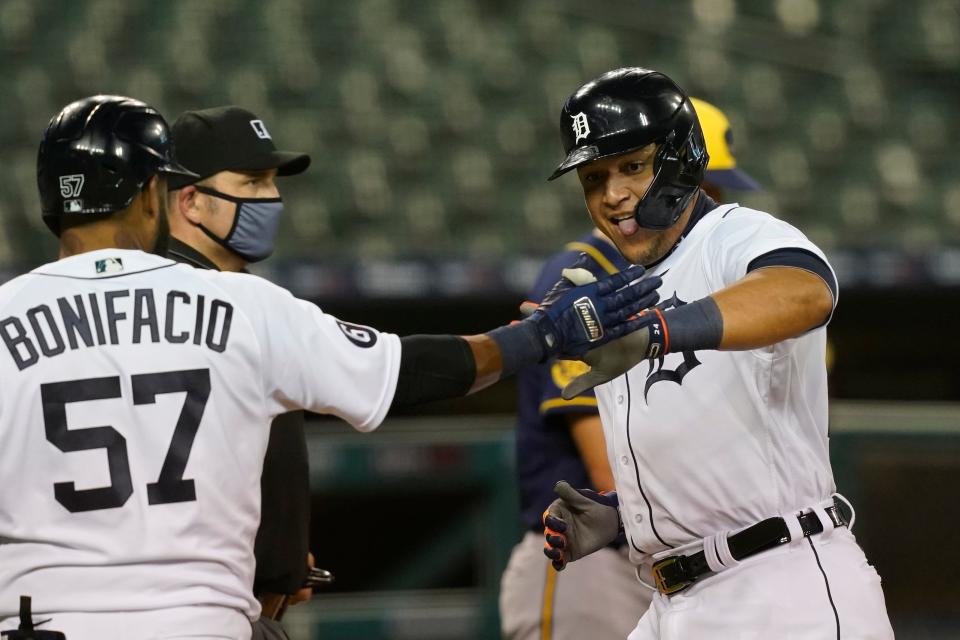 Tigers designated hitter Miguel Cabrera, right, is greeted at home by right fielder Jorge Bonifacio after scoring from second on a hit by Willi Castro during the fourth inning against the Brewers on Tuesday, Sept. 8, 2020, at Comerica Park.