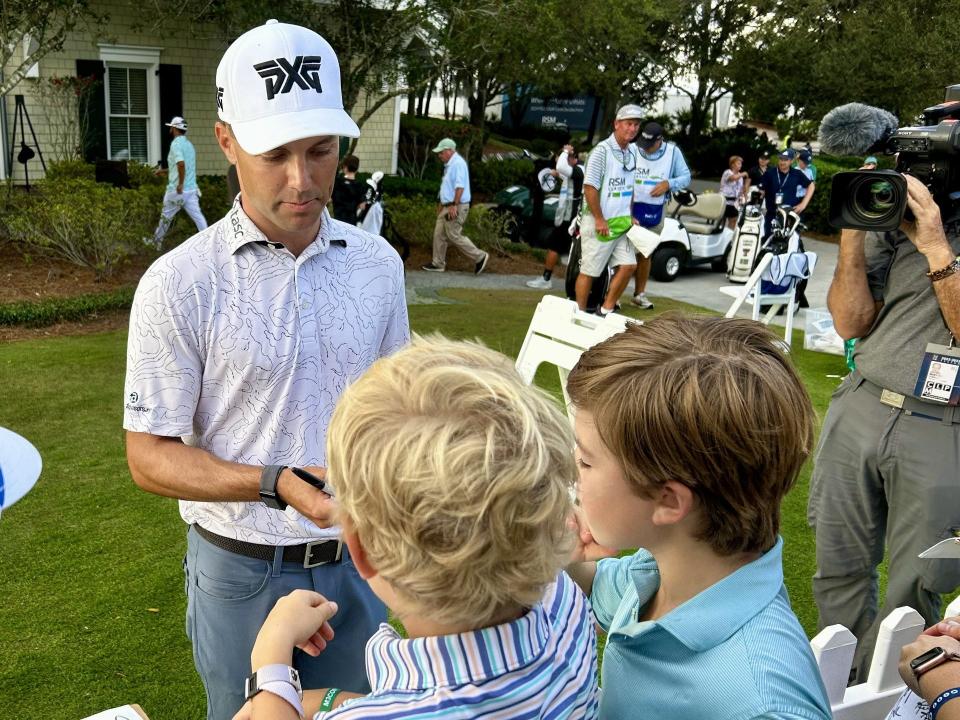 Eric Cole signs autographs for children after his third-round 61 in the RSM Classic, at the Sea Island Club Seaside Course on Saturday.