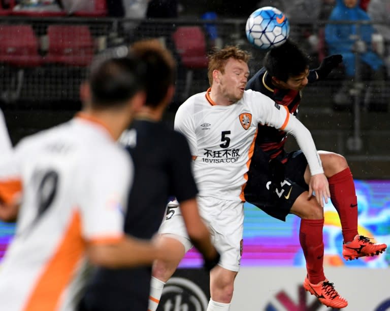 Kashima Antlers defender Yukitoshi Ito (right) battles for the ball with Brisbane Roar defender Corey Brown during an AFC Champions League clash in Kashima on March 14, 2017