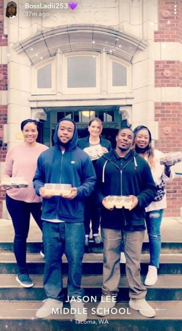 Zyion Houston-Sconiers, in front at right, and his co-defendant in the 2012 Halloween candy robbery, Treson Roberts, deliver cupcakes to Jason Lee Middle School in Tacoma, Washington, in 2018. (Photo courtesy of Arrogrance Wood-Houston)