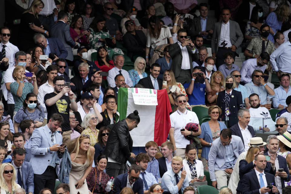 Fans cheer for Italy's Matteo Berrettini during the men's singles final match against Serbia's Novak Djokovic on day thirteen of the Wimbledon Tennis Championships in London, Sunday, July 11, 2021. (AP Photo/Alberto Pezzali)