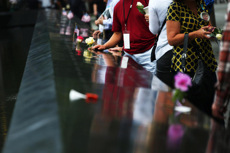 NEW YORK, NY - SEPTEMBER 11: People stand at the South Tower Reflecting Pool before the memorial observances held at the site of the World Trade Center before memorial observances are held at the site of the World Trade Center on September 11, 2014 in New York City. This year marks the 13th anniversary of the September 11th terrorist attacks that killed nearly 3,000 people at the World Trade Center, Pentagon and on Flight 93.  (Photo by Chang W. Lee-Pool/Getty Images)