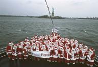<p>A group from Volunteers of America celebrate the organization's 100th anniversary with a cruise on the Hudson River in Santa suits. They had just collected money on the streets of the city for the poor and homeless.</p>