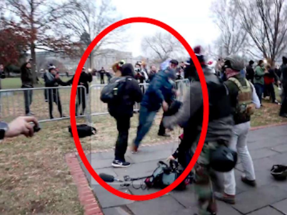 A screenshot from a video showing Woods assaulting a Reuters cameraman