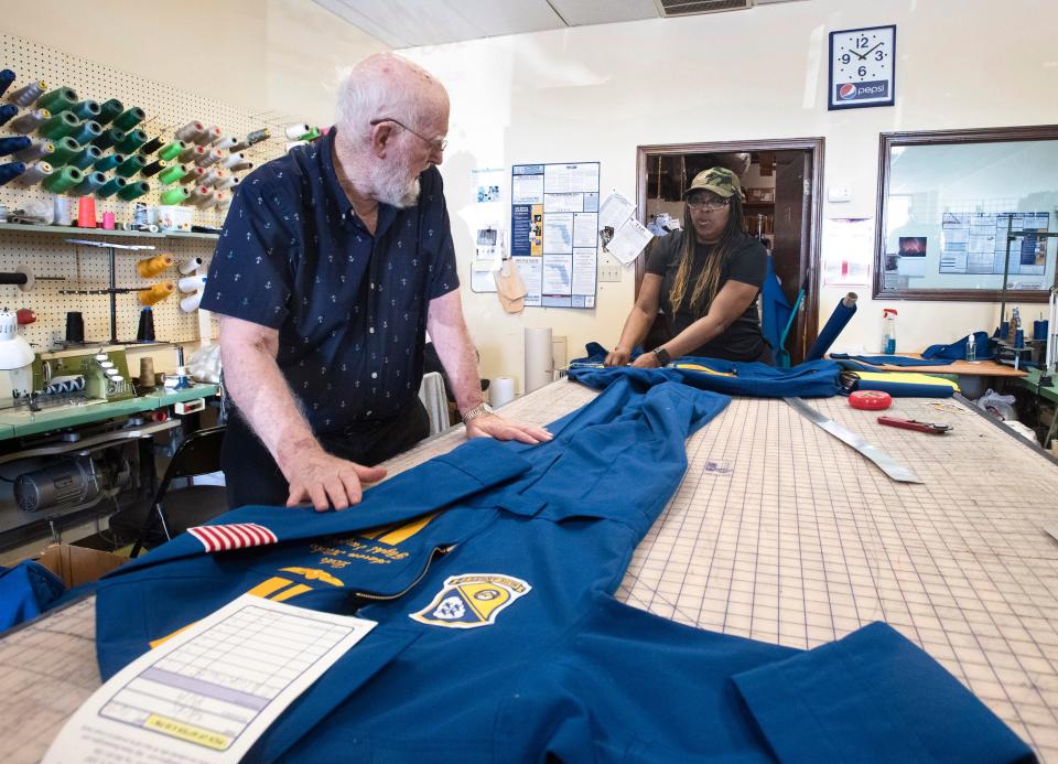 Sam Miller and Candy Whitehurst work on making flight suits for new members of the Blue Angels on July 25, 2019. Miller died Friday at age 84.