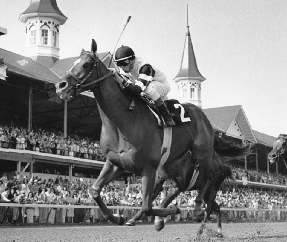 FILE - In this May 6, 1978, file photo, Affirmed, jockey Steve Cauthen up, crosses the finish line to win the Kentucky Derby in Louisville, Ky. Secretariat is the early 7-2 favorite for this weekend’s virtual Kentucky Derby, an animated race pitting all 13 Triple Crown winners on the day the Derby would have been held before the coronavirus pandemic postponed it. Citation, who won the 1948 Triple Crown, was made the 4-1 second choice. Seattle Slew and Affirmed, the 1977 and '78 Triple Crown winners, were each listed at 5-1 odds. (AP Photo/File)