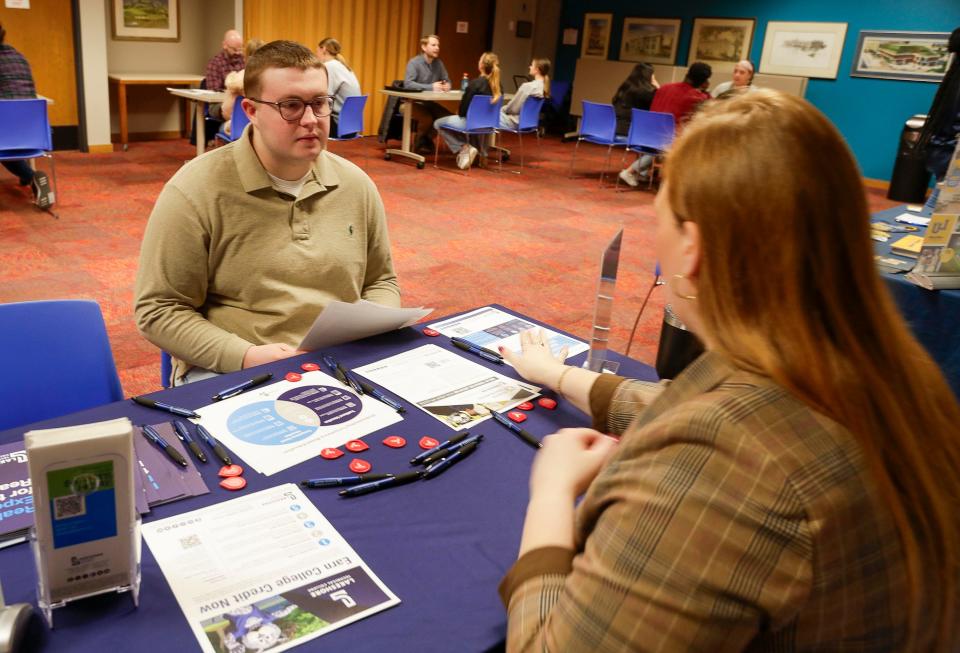 Sheboygan Falls’ Ryan Ballantine, lefts, listens to Lakeshore Technical College’s pathway manager Danielle Ourada explain how their education system works during the Sheboygan Chamber Junior Leadership program on education held at Mead Public Library, Tuesday, March 19, 2024, in Sheboygan, Wis.