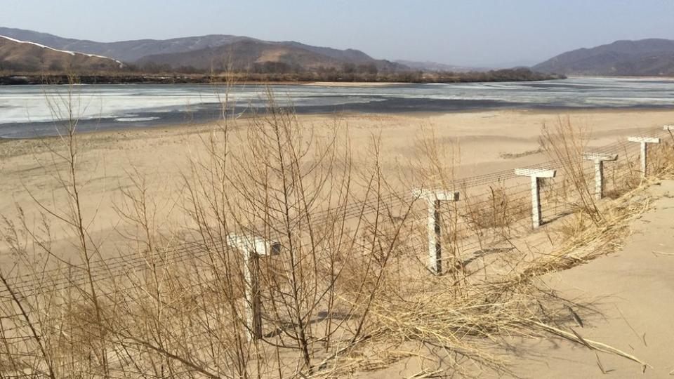 A barbed-wire fence separating North Korea from China is seen in this photo taken from the Chinese border city of Hunchun, China, March 18, 2015.