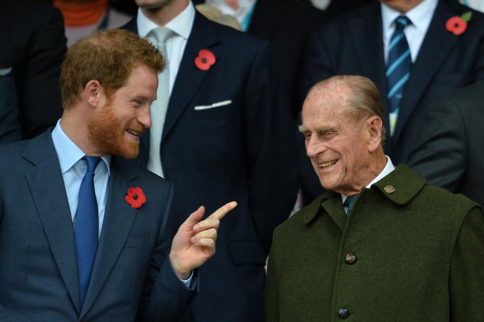 Prince Harry speaks with his grandfather Prince Philip as they watch the final match of the Rugby World Cup on Oct. 31, 2015. (Photo: GLYN KIRK via Getty Images)