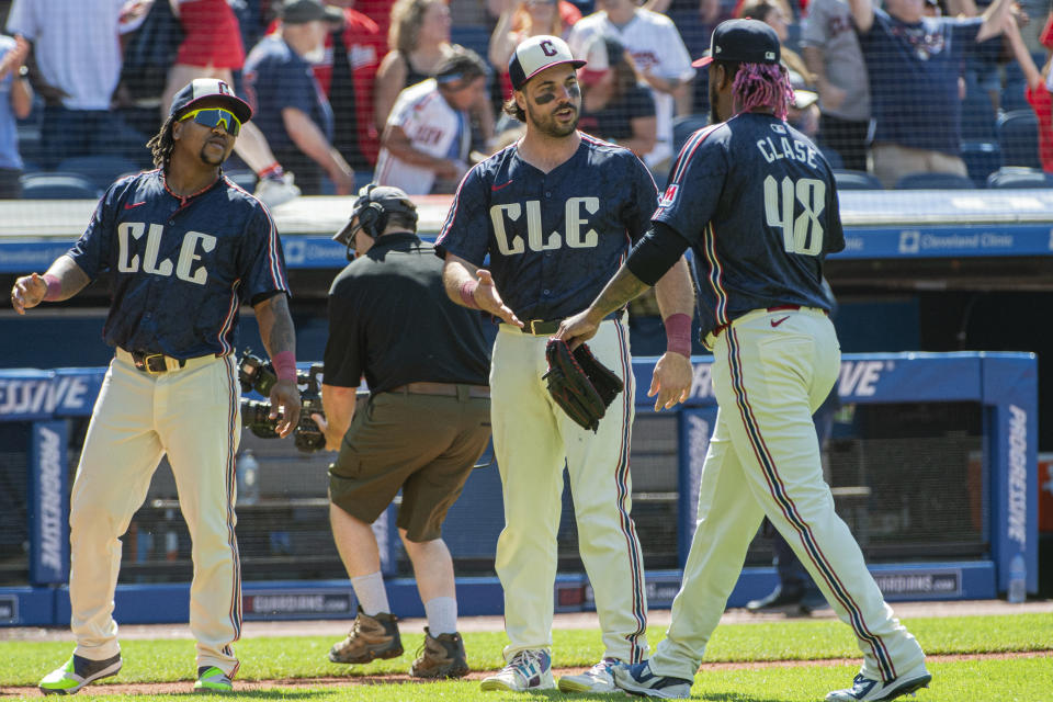 Cleveland Guardians' Austin Hedges, center, greets Emmanuel Clase as Jose Ramirez, left, waits at the end of a baseball game in Cleveland, Sunday, July 7, 2024. (AP Photo/Phil Long)