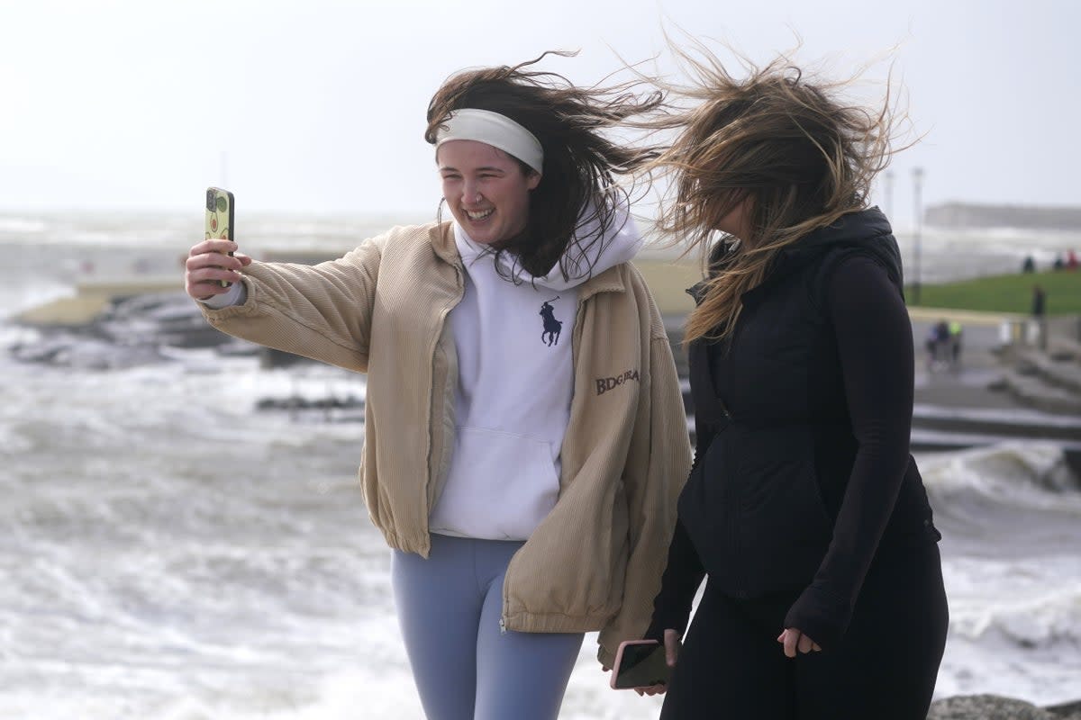 People take a selfie as Storm Kathleen hits the coast (PA)