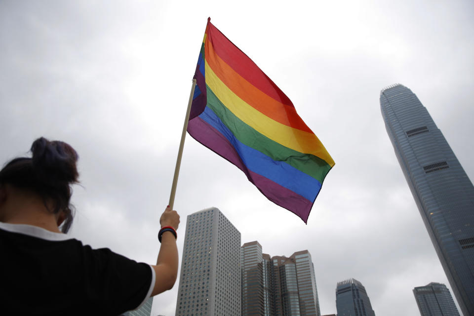 A participant holds rainbow flag at the annual Pride Parade In Hong Kong, Saturday, Nov. 17, 2018. Thousands of supporters and members of the Lesbian, Gay, Bisexual, Transgender (LGBT) community in Hong Kong gathered on Saturday to participate in the annual Pride Parade. (AP Photo/Kin Cheung)