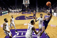 TCU forward Xavier Cork (12) shoots over Kansas State forward David N'Guessan (3) during the first half of an NCAA college basketball game Tuesday, Feb. 7, 2023, in Manhattan, Kan. (AP Photo/Charlie Riedel)