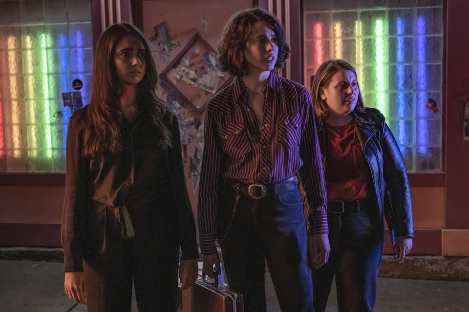 This image released by Focus Features shows Geraldine Viswanathan, left, Margaret Qualley and Beanie Feldstein, right, in a scene from "Drive-Away Girls." (Wilson Webb/Focus Features via AP)