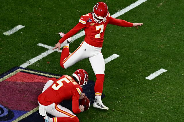 <p>PATRICK T. FALLON/AFP via Getty</p> Harrison Butker of the Kansas City Chiefs kicks the ball during Super Bowl LVIII.