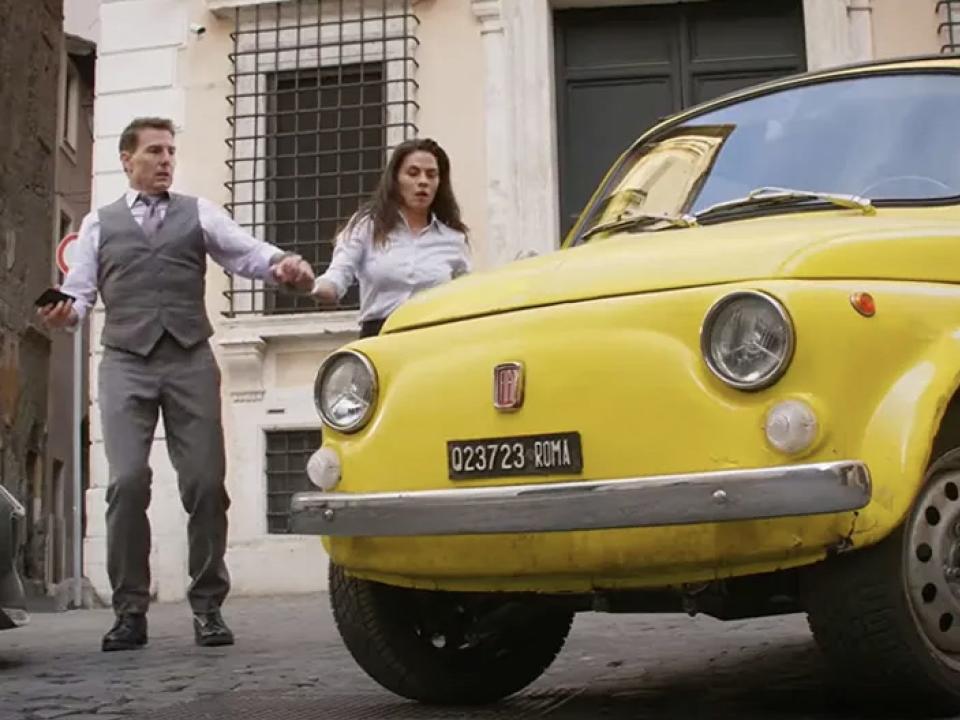 Tom Cruise and Hayley Atwell next to the yellow Fiat 500 in "Mission: Impossible - Dead Reckoning Part One."