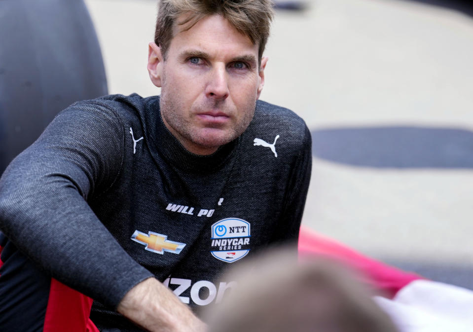 FILE - Will Power, of Australia, sits on the track before the Indianapolis 500 auto race at Indianapolis Motor Speedway in Indianapolis, May 29, 2022. The IndyCar season begins Sunday, March 5, 2023, with the Grand Prix of St. Petersburg. (AP Photo/AJ Mast, File)