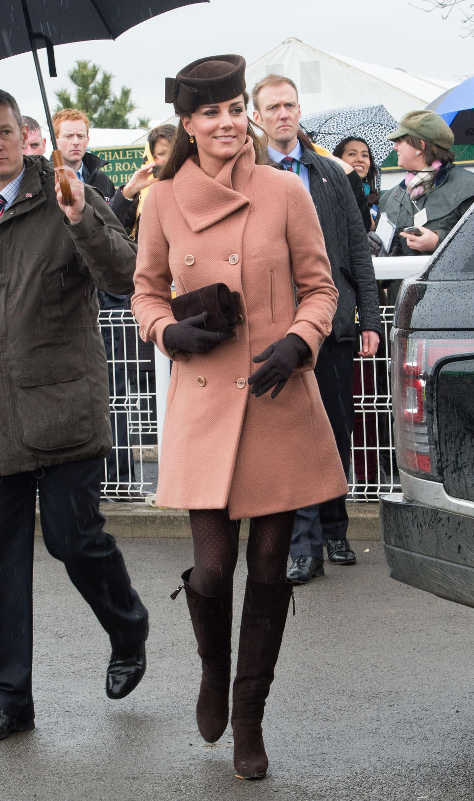 <p>Back in the days when Kate wore shorter styles, here for the 2013 Cheltenham Festival, the royal dressed in a wool Joseph coat and knee-high suede boots. (Photo: PA) </p>