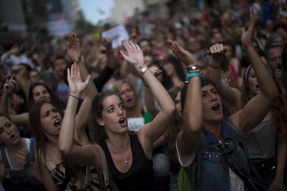 Demonstrators shout slogans during a protest to mark the anniversary of the beginning of the "Indignados" movement in Barcelona, Spain, Saturday May 12, 2012. Spanish activists angered by grim economic prospects planned nationwide demonstrations Saturday to mark the one-year anniversary of their protest movement that inspired similar groups in other countries. The protests began May 15 last year and drew hundreds of thousands of people calling themselves the Indignant Movement. The demonstrations spread across Spain and Europe as anti-austerity sentiment grew. (AP Photo/Emilio Morenatti)