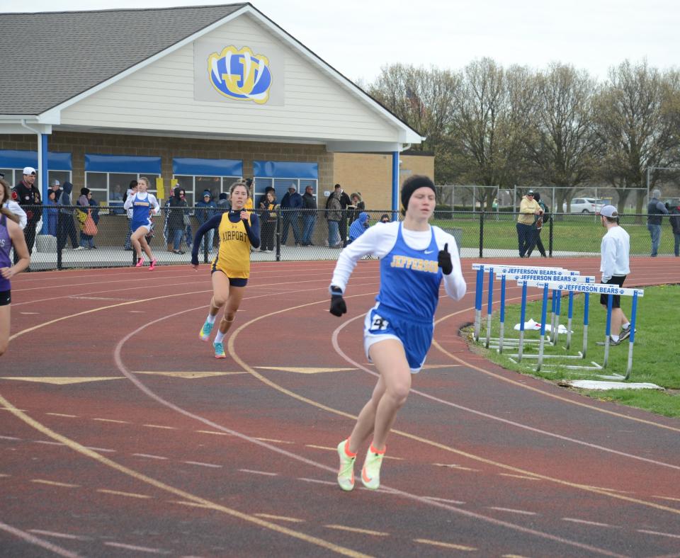 Alexa Glancy of Jefferson makes the final turn on her way to victory in the girls 400 meters at the Jefferson Invitational Saturday. Trailing is Tara Szuper of Airport.