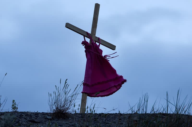 FILE PHOTO: Child's red dress hangs on a stake near the former Kamloops Indian Residential School