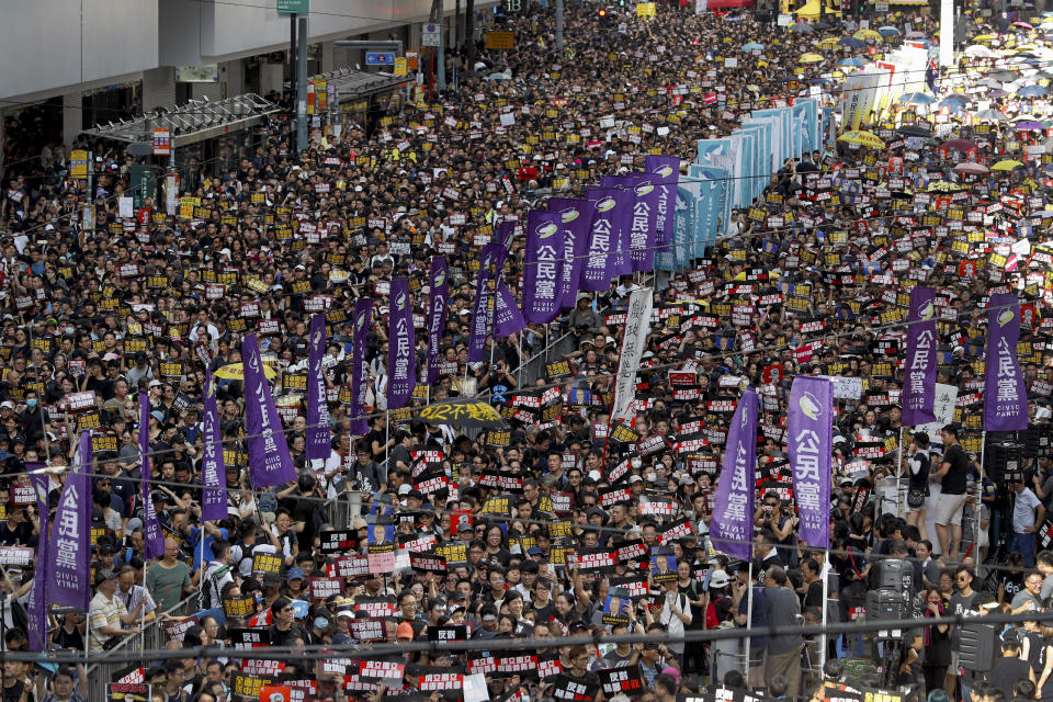 Protesters take part in a march on a street in Hong Kong, Sunday, July 21, 2019. Thousands of Hong Kong protesters marched from a public park to call for an independent investigation into police tactics. (AP Photo/Vincent Yu)