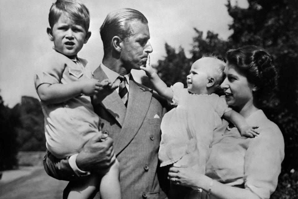 Daddy's girl: Princess Anne reaches up to her father as he holds Prince Charles (OFF/AFP/Getty Images)