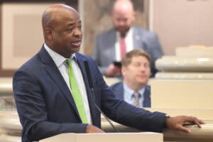 A man in a blue suit and green tie