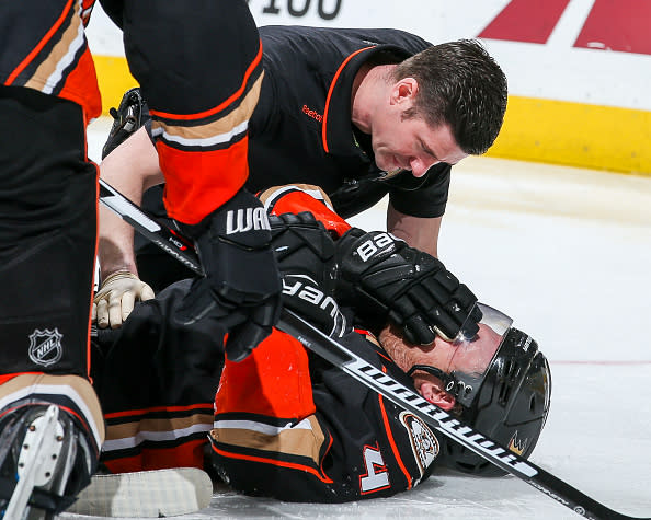 ANAHEIM, CA - APRIL 4: Athletic trainer Joe Huff of the Anaheim Ducks examines Cam Fowler #4 after a hit during the third period of the game against the Calgary Flames at Honda Center on April 4, 2017 in Anaheim, California. Fowler was helped off the ice after the examination. (Photo by Debora Robinson/NHLI via Getty Images) ***Local Caption ***