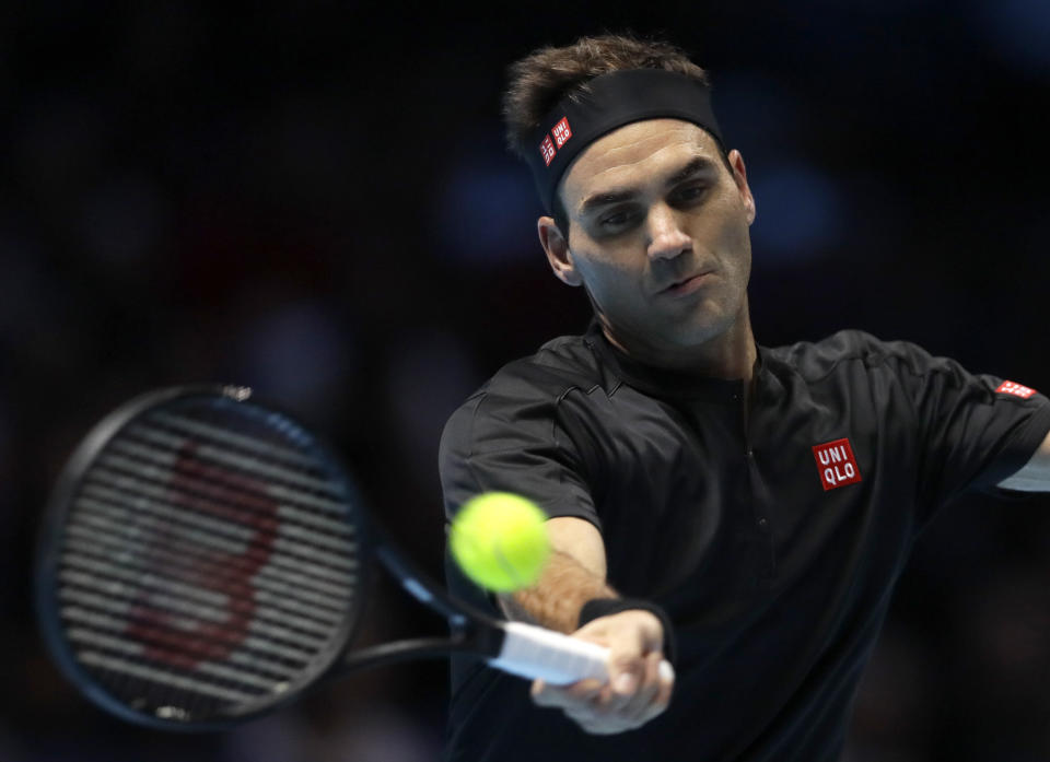 Roger Federer of Switzerland plays a return to Stefanos Tsitsipas of Greece during their ATP World Tour Finals semifinal tennis match at the O2 Arena in London, Saturday, Nov. 16, 2019. (AP Photo/Kirsty Wigglesworth)