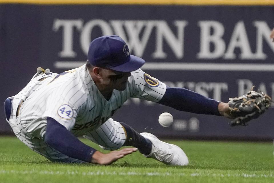 Milwaukee Brewers' Luis Urias can't catch a ball hit by St. Louis Cardinals' Edmundo Sosa during the third inning of a baseball game Friday, Sept. 3, 2021, in Milwaukee. (AP Photo/Morry Gash)