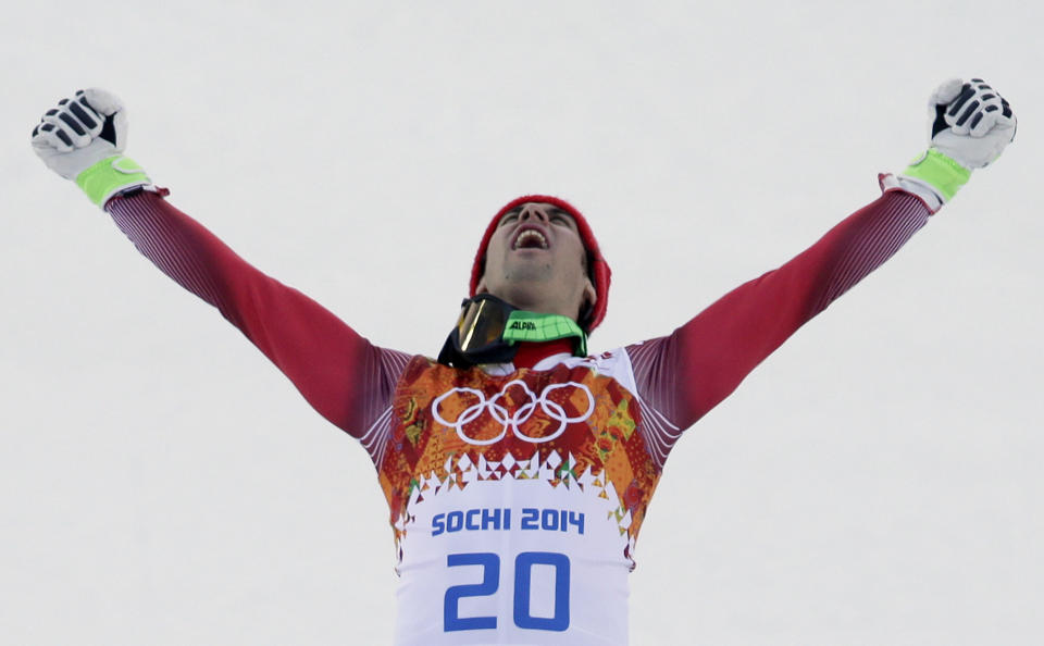 Men's supercombined gold medal winner Switzerland's Sandro Viletta celebrates on the podium during a flower ceremony at the Sochi 2014 Winter Olympics, Friday, Feb. 14, 2014, in Krasnaya Polyana, Russia. (AP Photo/Gero Breloer)