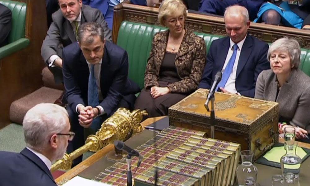 Theresa May listens as Jeremy Corbyn announces the no-confidence motion against her on in the Commons on Monday.