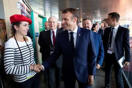 French President Macron tours the exhibition hall above the international press center on the opening day of the G7 summit, in Anglet