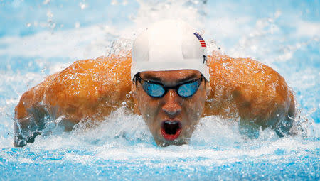 FILE PHOTO: Michael Phelps of the U.S. swims to a first place finish in his men's 100m butterfly heat during the London 2012 Olympic Games at the Aquatics Centre August 2, 2012. REUTERS/David Gray/File Photo