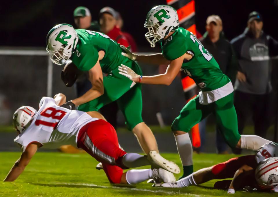 Riverside's Robert Janis rumbles and stumbles over Freedom's Nathan Dinardo and into the endzone during their game Friday at Riverside High School. [Lucy Schaly/For BCT]