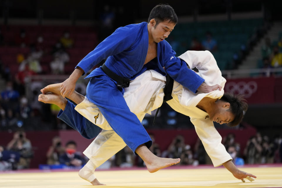 THIS CORRECTS TO GOLD, NOT BRONZE - Naohisa Takato of Japan, left, and Yang Yung-wei of Taiwan compete during their men's -60kg gold medal judo match at the 2020 Summer Olympics, Saturday, July 24, 2021, in Tokyo, Japan. (AP Photo/Vincent Thian)