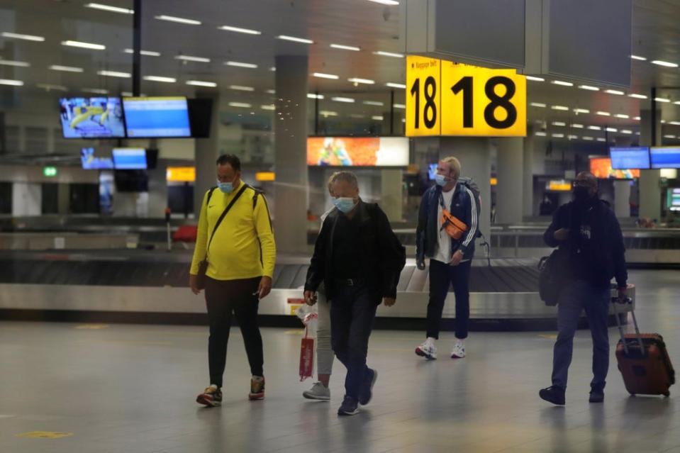 Thirteen travellers who flew into Schiphol Airport (pictured) have tested positive for the Omicron variant   (REUTERS)