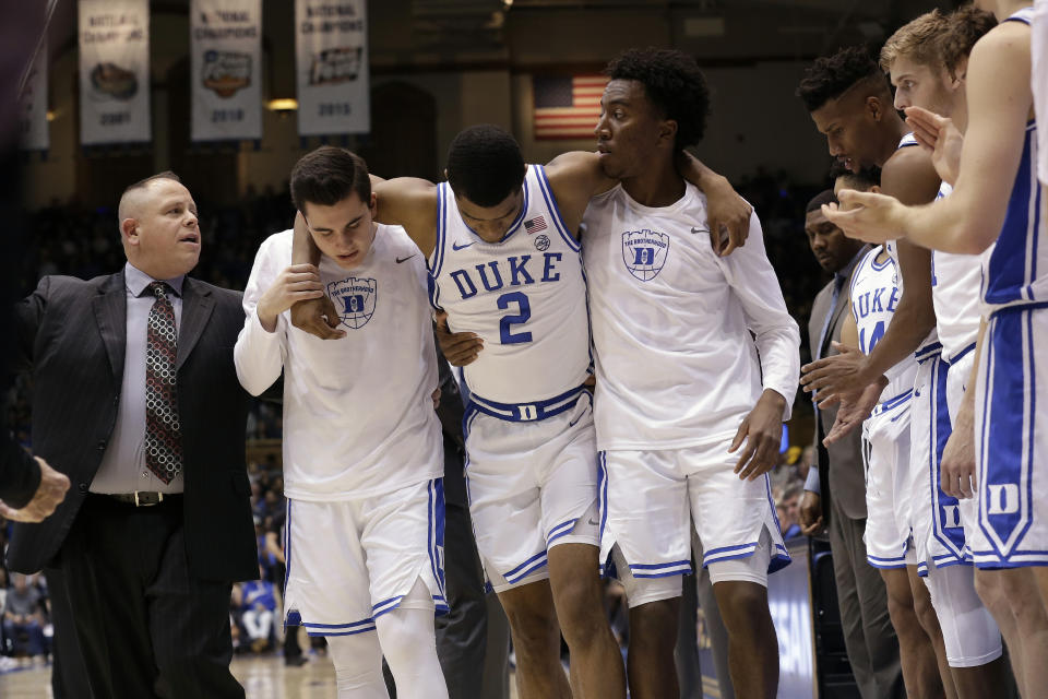 Duke guard Cassius Stanley is assisted off the court by teammates following an injury during the second half of their game against Winthrop on Friday.