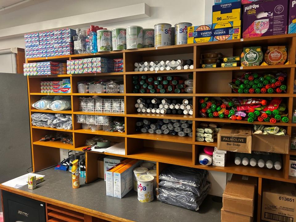 A tuck shop is open three days a week providing snacks and essentials (The Independent)